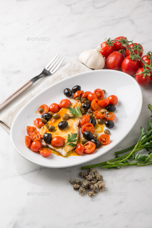 swordfish with tomatoes capers and olive Stock Photo by